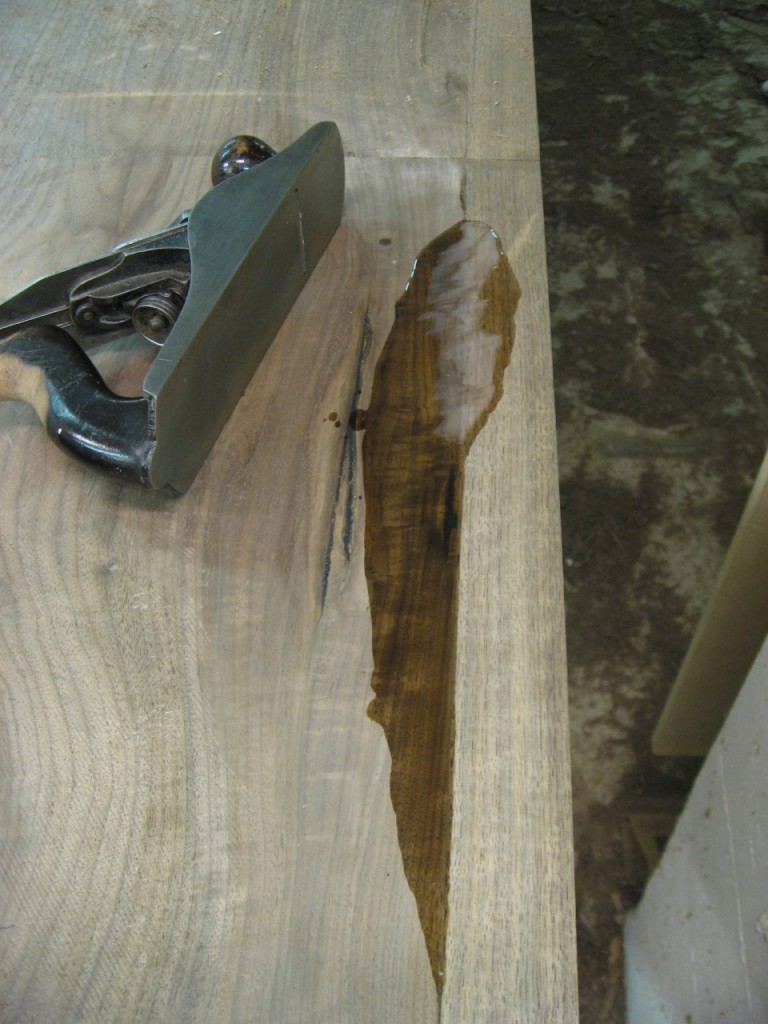 The dry epoxy fills a low spot, ready to be leveled with a hand plane