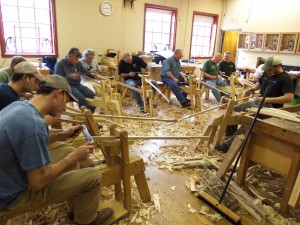 Students are continuing their ride on the shave horses as they work to dimension and shape the 60" long continuous arm of the chair.
