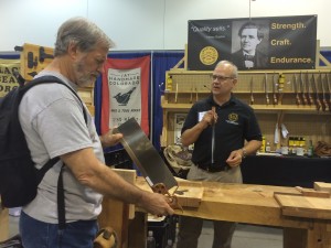 Chris Bagby taking a look at the beautiful Bad Axe saws made by Mark Harrell
