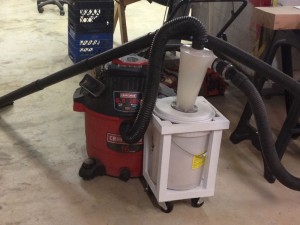 “They” don’t make ‘em like this any more. Modern shop vacuum hoses are stiff, and would tend to topple the Dust Deputy over. This soft hose tucks the Dust Deputy in. The homemade cart is bottom-weighted to add stability.