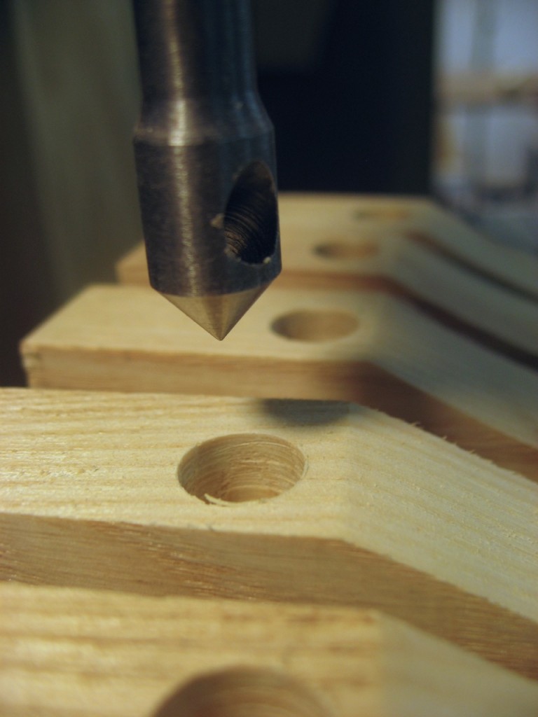 A countersink bit is used in the drill press for clean holes