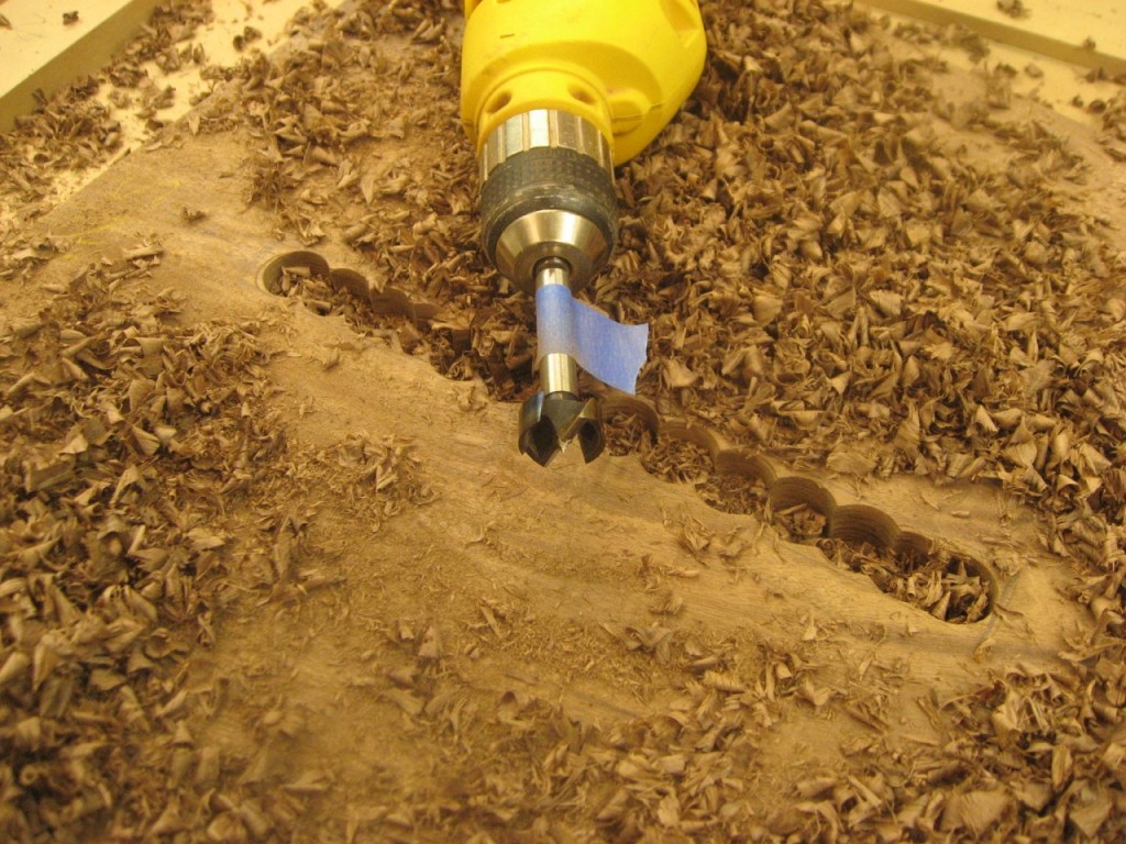 Excavate most of the material using a fortsner bit a drill