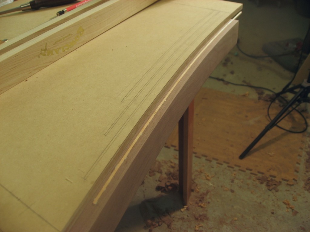 Template clamped, groove routed and inlay glued in place.