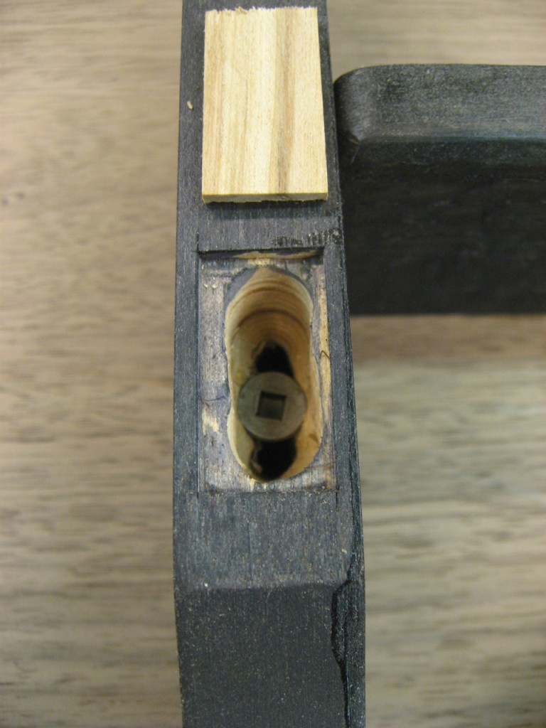 The elongated clearance hole has square edges to match the patch