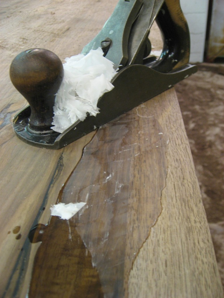 A hand plane cuts epoxy very well, taking glue shavings!