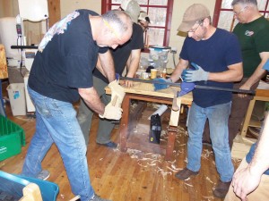 students are continuing their ride on the shave horses as they work to dimension and shape the 60" long continuous arm of the chair.