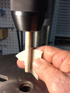 Run the speed up pretty high and it will take only a minute or so to get a perfectly smooth surface with a scrap of 400-grit paper. Swap ends and smooth the entire rod. Be conservative with chuck pressure.